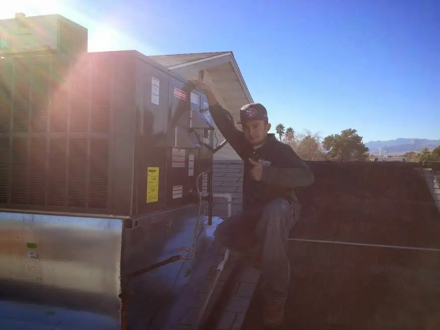 HVAC technician performing HVAC Inspection on a rooftop unit in Lincoln Park